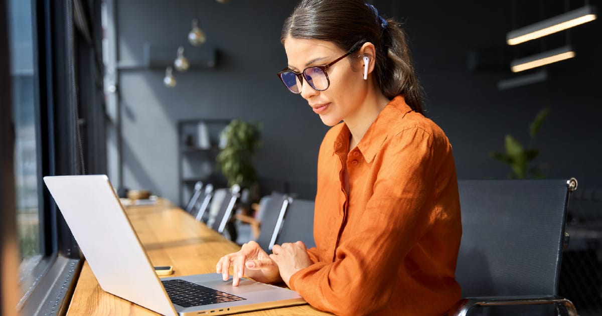 A young woman reviewing her financial plan on a laptop