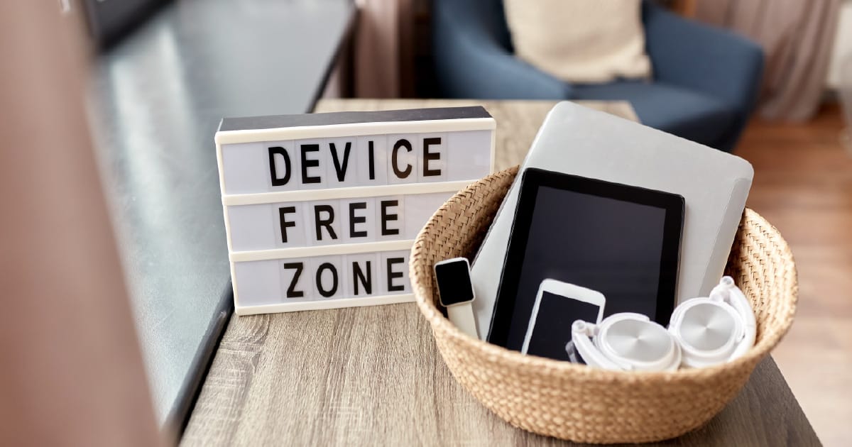‘Device Free Zone’ on a sign in a comfortable looking room meant to represent a digital detox