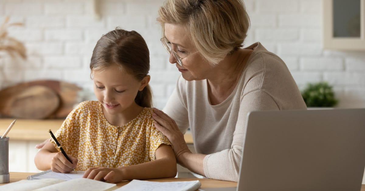 2026-07-grandmasocial-wide A grandmother teaching her granddaughter about finances